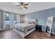 This main bedroom features hard wood floors, a large window and a cieling fan at 1126 Barclay Wood Dr, Ruskin, FL 33570