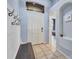 Bright foyer featuring tile floors, coat hooks, and natural light from a transom window at 1126 Barclay Wood Dr, Ruskin, FL 33570