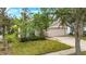 Well-maintained single-story home with a two-car garage and lush front yard landscaping at 1126 Barclay Wood Dr, Ruskin, FL 33570