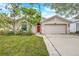 Charming single Gathering home featuring a well-maintained lawn and inviting front entry at 1126 Barclay Wood Dr, Ruskin, FL 33570