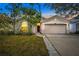 Charming single Gathering home at dusk featuring a well-maintained lawn and inviting front entry at 1126 Barclay Wood Dr, Ruskin, FL 33570