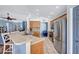 Open concept kitchen featuring stainless steel appliances and bar seating facing the living room at 1126 Barclay Wood Dr, Ruskin, FL 33570