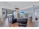 Comfortable living room featuring wood-look floors, ceiling fan, and natural light at 1126 Barclay Wood Dr, Ruskin, FL 33570