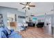 Open living room with ceiling fans, wood floors, modern furnishings and an open view to the kitchen at 1126 Barclay Wood Dr, Ruskin, FL 33570