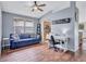 Comfortable living room with wood floors, couch, and work space at 1126 Barclay Wood Dr, Ruskin, FL 33570
