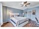 Spacious main bedroom with hardwood floors, a large window, and a ceiling fan at 1126 Barclay Wood Dr, Ruskin, FL 33570