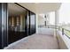 Spacious balcony featuring tile flooring, railing and sliding glass doors leading inside at 1255 N Gulfstream Ave # 1104, Sarasota, FL 34236