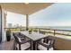 Spacious covered balcony with an outdoor dining set and expansive views of the city and waterfront at 1255 N Gulfstream Ave # 1104, Sarasota, FL 34236