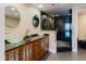 Modern bathroom with double vanity, glass sinks, wood cabinetry and a walk-in shower at 1255 N Gulfstream Ave # 1104, Sarasota, FL 34236
