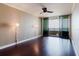 Bright bedroom with beautiful dark wood floors and a sliding glass door to a balcony with views at 1255 N Gulfstream Ave # 1104, Sarasota, FL 34236
