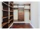 Walk-in closet with custom shelving and drawers, offering ample storage space for any wardrobe at 1255 N Gulfstream Ave # 1104, Sarasota, FL 34236