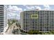 A condo exterior featuring a high-rise building with large windows and a sunny view at 1255 N Gulfstream Ave # 1104, Sarasota, FL 34236