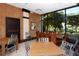 Bright conference room with large windows, several tables, and views of the outdoors at 1255 N Gulfstream Ave # 1104, Sarasota, FL 34236