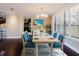Bright dining room with white wood trim, modern light fixture and beach themed decor at 1255 N Gulfstream Ave # 1104, Sarasota, FL 34236