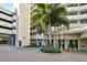 Elegant building entrance surrounded by beautiful landscaping and a circular driveway for convenient access at 1255 N Gulfstream Ave # 1104, Sarasota, FL 34236