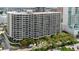 Stunning exterior shot of the high-rise condo building, complemented by lush greenery and cityscape views at 1255 N Gulfstream Ave # 1104, Sarasota, FL 34236