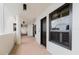 Exterior hallway featuring tile flooring, overhead lighting, and condo entrance at 1255 N Gulfstream Ave # 1104, Sarasota, FL 34236