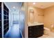 Hallway leads to a bathroom with a dark vanity and a white countertop at 1255 N Gulfstream Ave # 1104, Sarasota, FL 34236