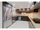 Contemporary kitchen with stainless steel appliances, wine cooler, and dark wood cabinetry at 1255 N Gulfstream Ave # 1104, Sarasota, FL 34236