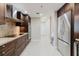 Well-lit kitchen with updated appliances, dark cabinets, and ample counter space at 1255 N Gulfstream Ave # 1104, Sarasota, FL 34236