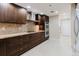 Modern kitchen showcasing rich wood cabinets, stainless appliances, and granite countertops at 1255 N Gulfstream Ave # 1104, Sarasota, FL 34236