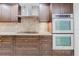 Modern kitchen featuring a range hood, stainless ovens, and granite counters at 1255 N Gulfstream Ave # 1104, Sarasota, FL 34236
