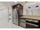 Kitchen featuring stainless steel appliances, custom cabinets, granite countertops, and wine cooler at 1255 N Gulfstream Ave # 1104, Sarasota, FL 34236