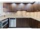 Gourmet kitchen boasts granite countertops, custom wood cabinetry, and stainless steel dishwasher at 1255 N Gulfstream Ave # 1104, Sarasota, FL 34236