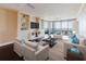 Bright living room with hardwood floors, built-in shelving, and comfortable seating at 1255 N Gulfstream Ave # 1104, Sarasota, FL 34236