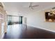 Spacious living area boasting hardwood floors and adjacent kitchen with dark cabinets and granite countertops at 1255 N Gulfstream Ave # 1104, Sarasota, FL 34236