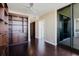 Spacious living room features built-in shelving, dark hardwood floors, and sliding glass doors to the balcony at 1255 N Gulfstream Ave # 1104, Sarasota, FL 34236