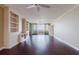 Open living area features hardwood floors, built-in shelving, and balcony access at 1255 N Gulfstream Ave # 1104, Sarasota, FL 34236