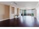 Bright living room with custom built-in shelving and access to a private balcony with a water view at 1255 N Gulfstream Ave # 1104, Sarasota, FL 34236