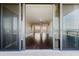 View from the balcony to the home's interior, showcasing dark hardwood floors at 1255 N Gulfstream Ave # 1104, Sarasota, FL 34236