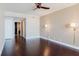 A neutral colored living room with hardwood floors is lit by sconces and a ceiling fan at 1255 N Gulfstream Ave # 1104, Sarasota, FL 34236