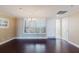 Bright and airy living room boasting rich hardwood floors and white shuttered windows at 1255 N Gulfstream Ave # 1104, Sarasota, FL 34236