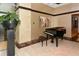 Open lobby area featuring a piano, artwork, and a stylish plant in a decorative pot at 1255 N Gulfstream Ave # 1104, Sarasota, FL 34236