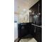 Close up of a dark tile shower with pebble floor and hand rails at 1255 N Gulfstream Ave # 1104, Sarasota, FL 34236