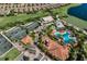 Aerial view showcasing the community's tennis courts, pool, clubhouse, and lush landscaping at 13338 Torresina Ter, Lakewood Ranch, FL 34211