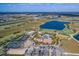 Expansive aerial view of a community with a large lake, golf course, clubhouse, pool, and tennis courts at 13338 Torresina Ter, Lakewood Ranch, FL 34211