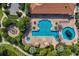 Aerial view of the pool and sundeck area surrounded by lush landscaping at 13338 Torresina Ter, Lakewood Ranch, FL 34211