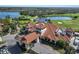 Aerial view of the community clubhouse and grounds with golf course and lakes at 13338 Torresina Ter, Lakewood Ranch, FL 34211