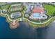 Aerial view of community amenities including the pool, clubhouse, tennis courts, and lake at 13338 Torresina Ter, Lakewood Ranch, FL 34211