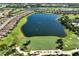 Aerial view of a community with a large lake, golf course, and residential area at 13338 Torresina Ter, Lakewood Ranch, FL 34211
