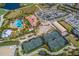 Aerial view of a community pool, clubhouse, tennis courts, bocce ball, playground, and putting green at 13338 Torresina Ter, Lakewood Ranch, FL 34211