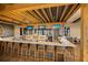 Community bar featuring lots of seating, televisions, light wood elements and liquor displays at 13338 Torresina Ter, Lakewood Ranch, FL 34211