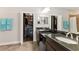 Bathroom featuring double vanity with granite countertop and walk in closet at 13338 Torresina Ter, Lakewood Ranch, FL 34211