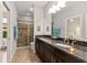 Modern bathroom featuring a granite countertop, dual vanity, and tiled glass shower at 13338 Torresina Ter, Lakewood Ranch, FL 34211