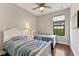 Shared bedroom with twin beds, natural light and ceiling fan at 13338 Torresina Ter, Lakewood Ranch, FL 34211
