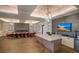 Large multi-purpose space including a long table and chairs, fireplace, kitchenette, and TV at 13338 Torresina Ter, Lakewood Ranch, FL 34211